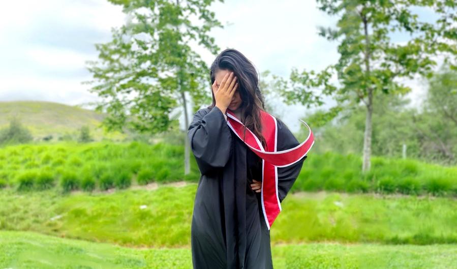 Graduation stole blowing to the side in the wind and ruining graduation photo